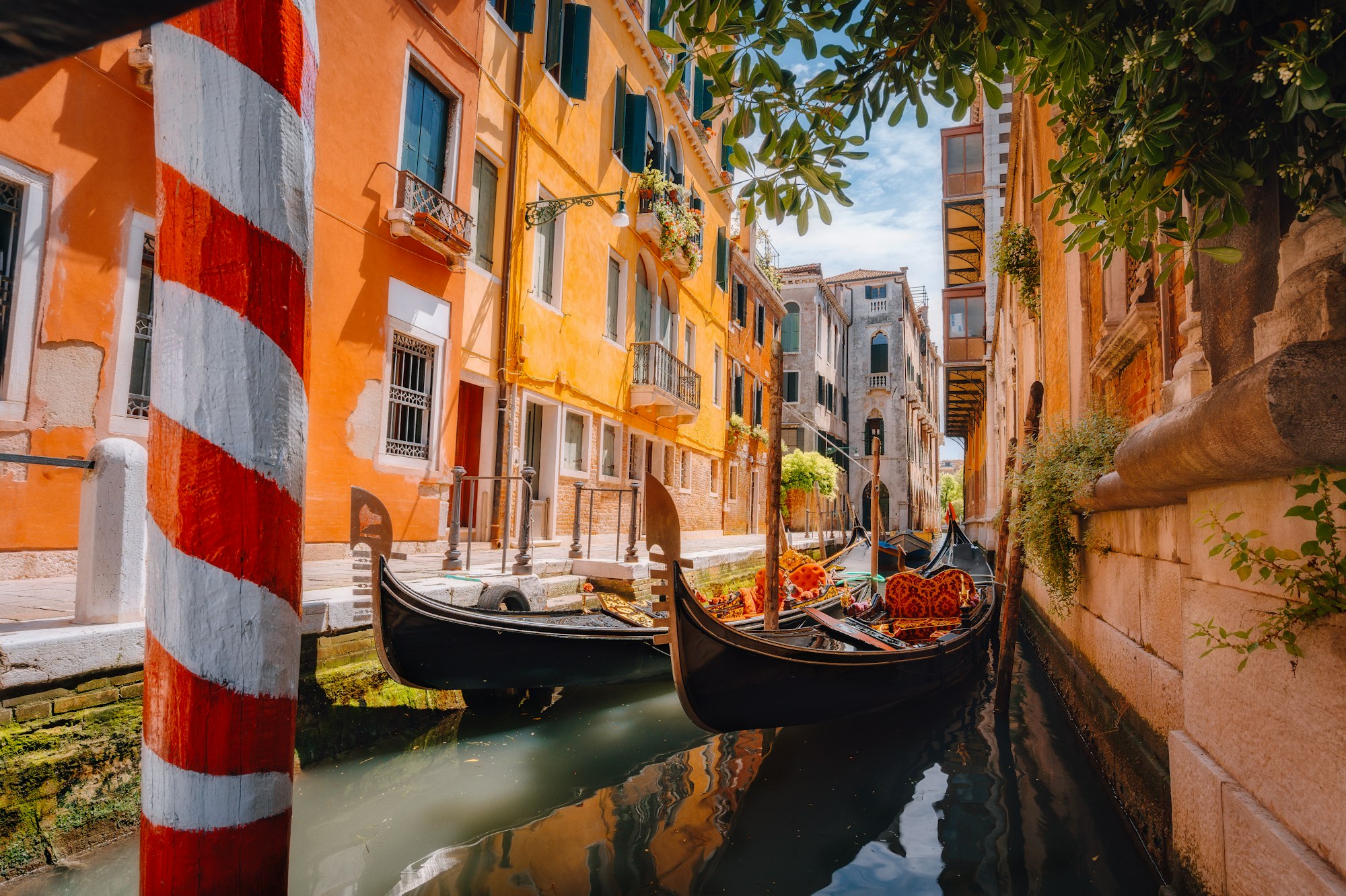 gondolas-boat-floating-in-narrow-canal-of-venice-city-on-beautiful-sunny-day-italy-europe.jpg